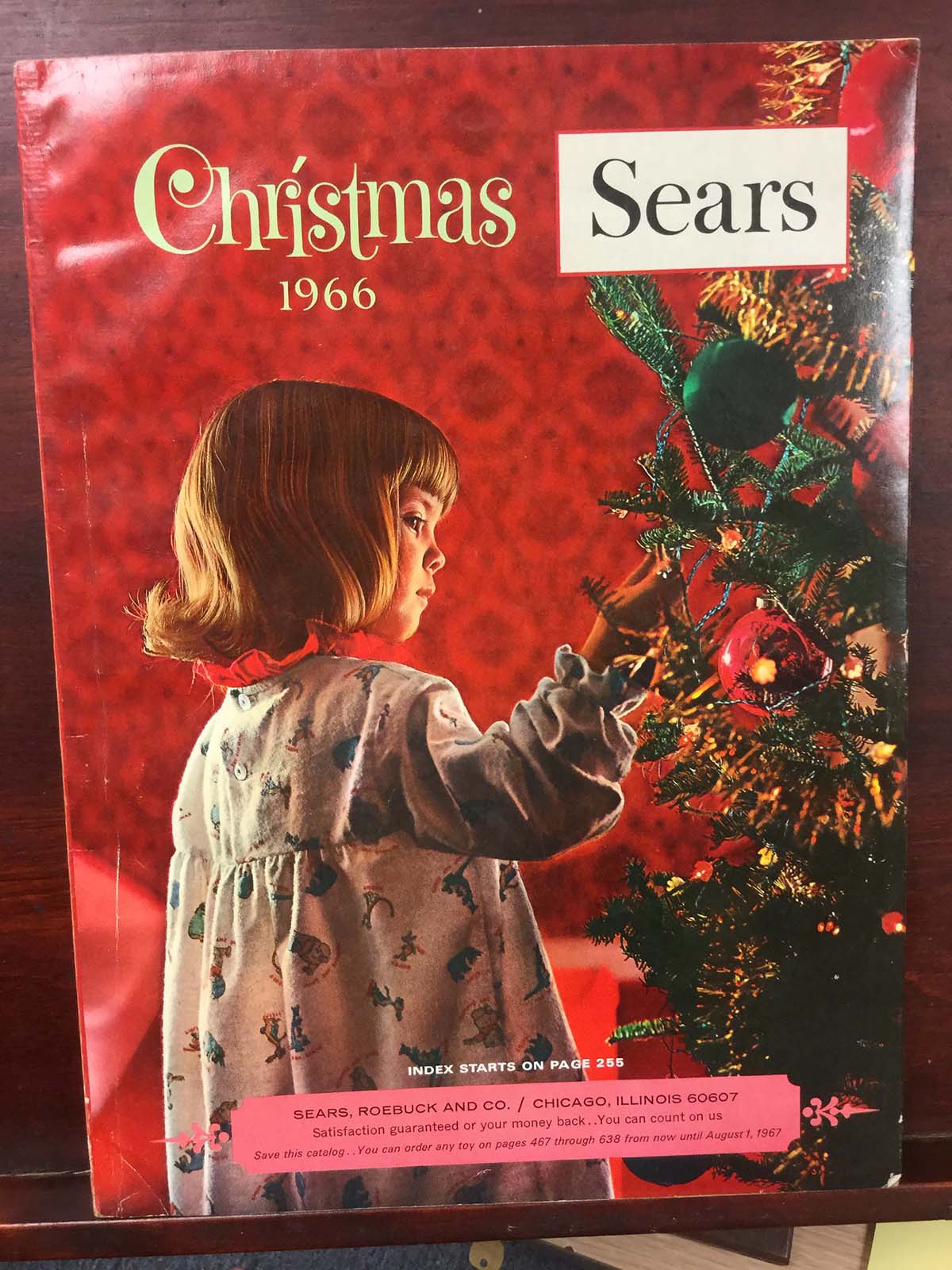 Catalogue cover showing child looking at a Christmas tree.