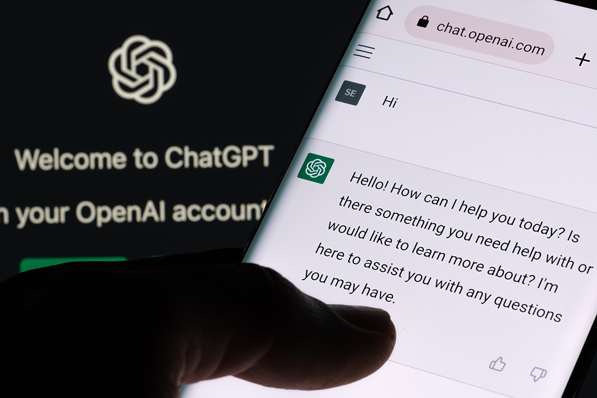 ChatGPT chat bot screen seen on smartphone and laptop display with Chat GPT login screen on the background.