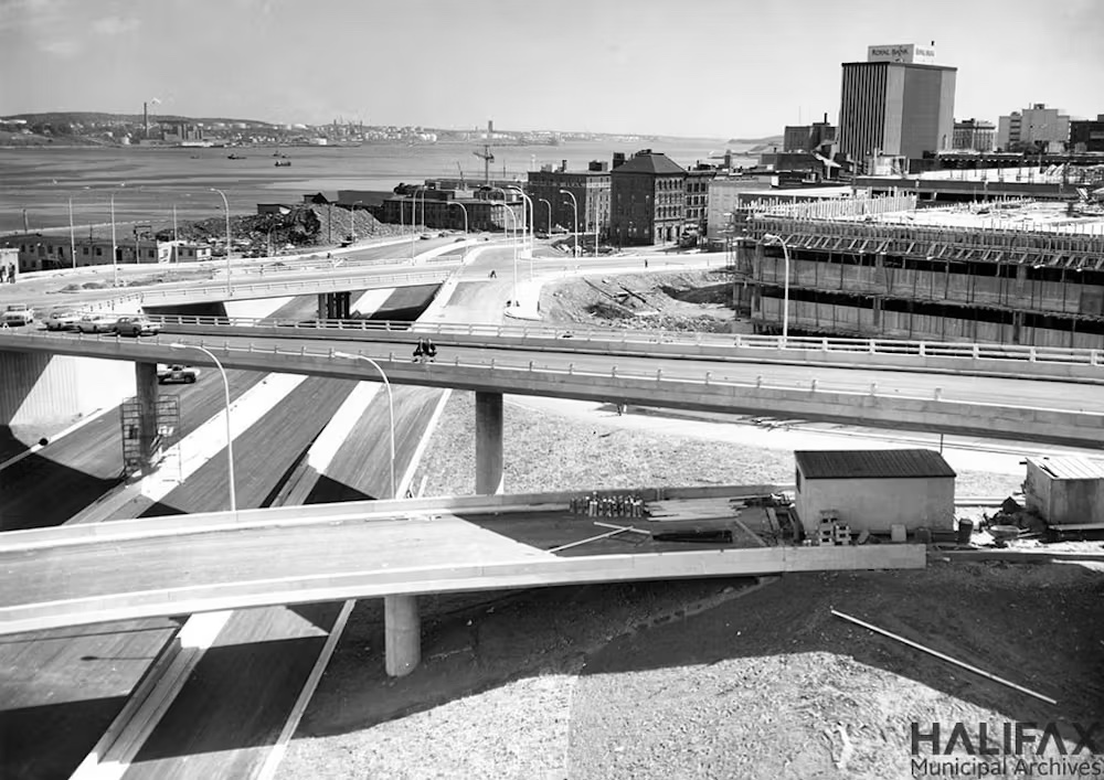A black and white photo of a highway with overpasses.