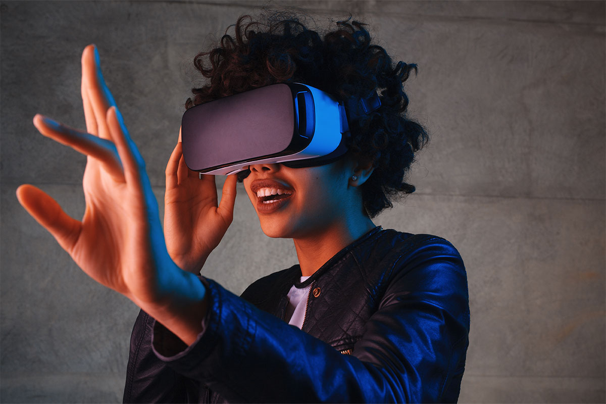 a woman wearing a vr headset with an outstretched hand.