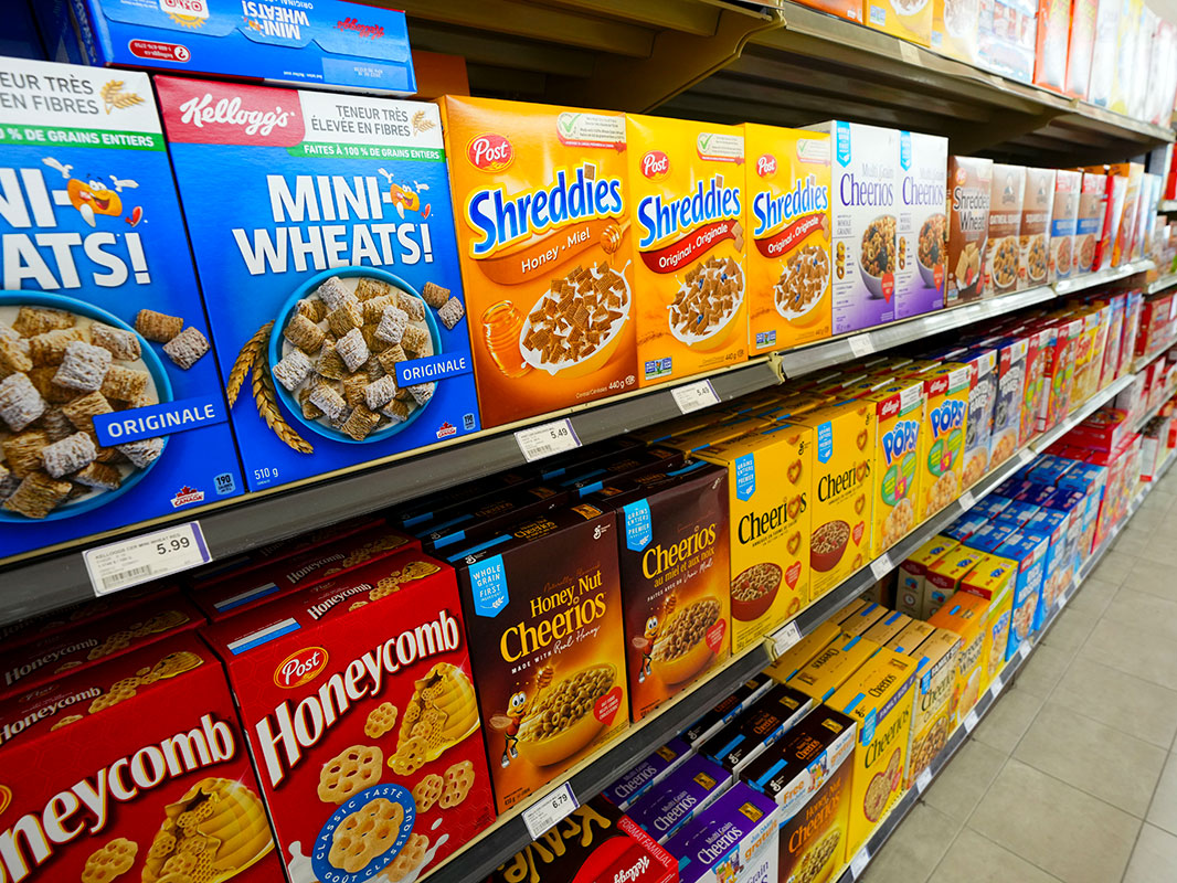 Cereals and cereal products displayed for sale at a grocery store.