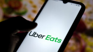 Uber Eats app logo visible on a phone screen.