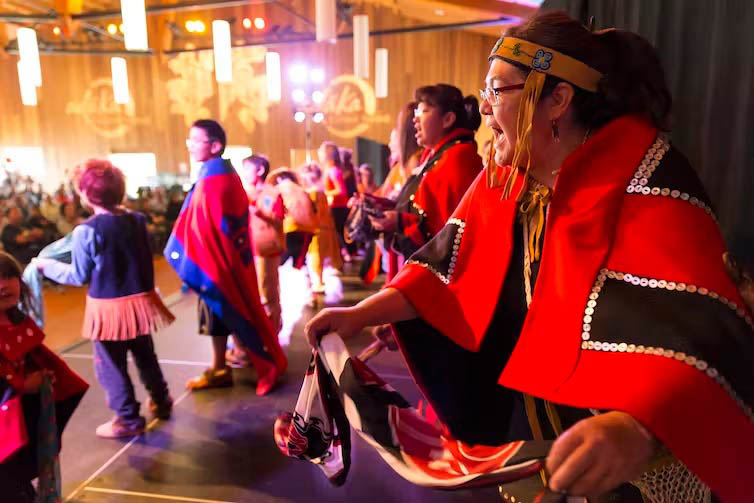 Indigenous women perform at a powwow.