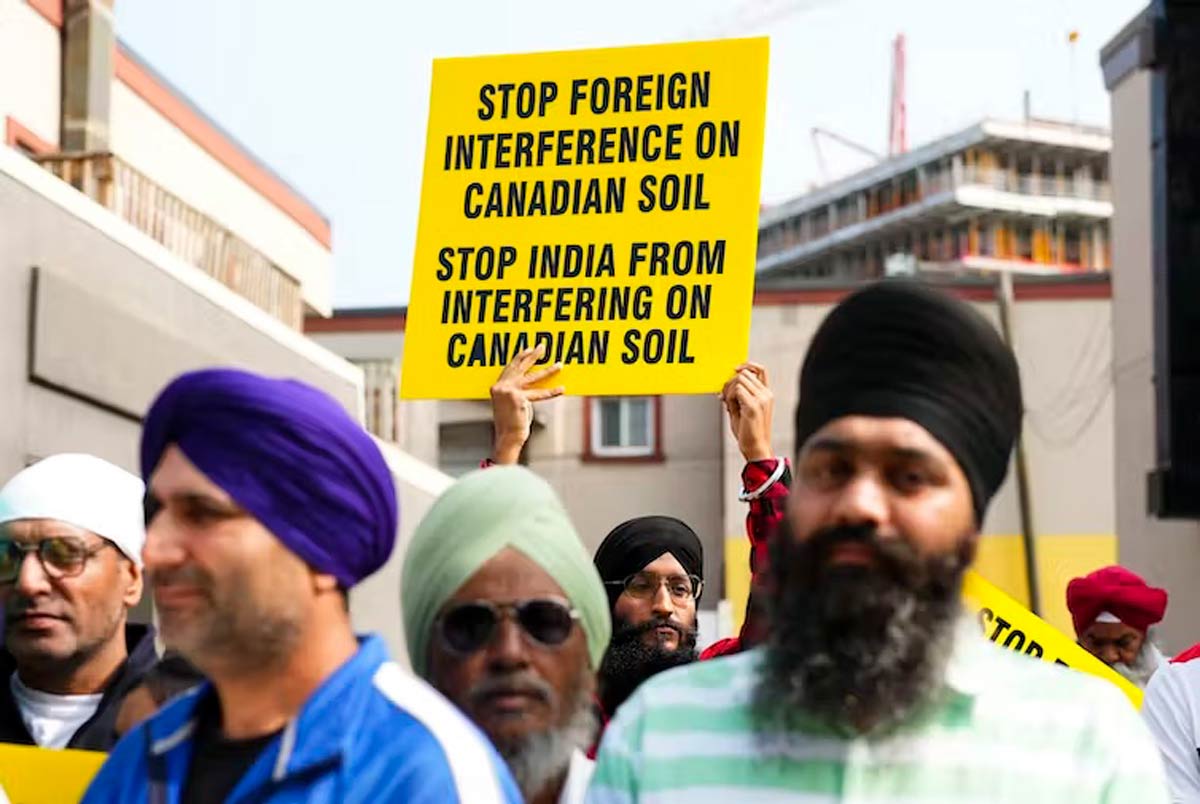 Men in turbans hold signs, one reading Stop India From Interfering on Canadian Soil