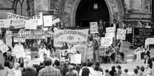 A demonstration on parliament hill in 1975 calling for equal pay and equal child custody rights for LGBTQ+ parents.