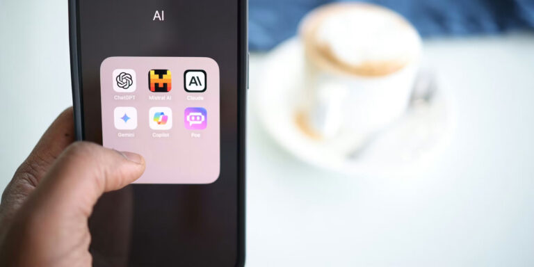 a hand holding a phone isplaying icons for AI apps